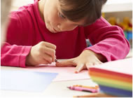 Child working intently at coloring