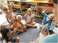 Preschool children raising hands