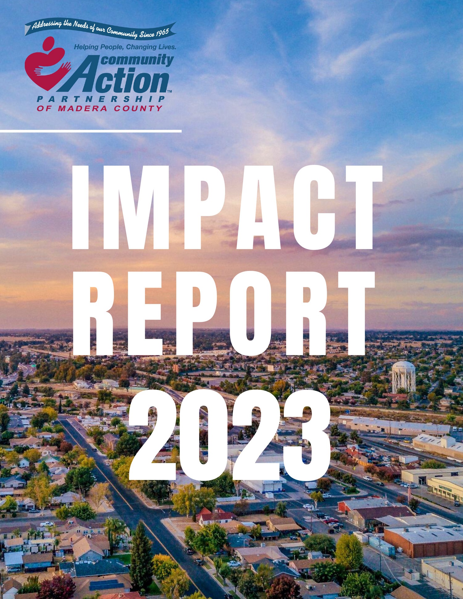 Cover of a report titled "Impact Report 2023" from Community Action Partnership of Madera County. The image features an aerial view of a community with streets and houses, set against a sunset sky. The organization's logo is in the top left corner, along with the slogans "Helping People, Changing Lives" and "Addressing the Needs of our Community Since 1965."